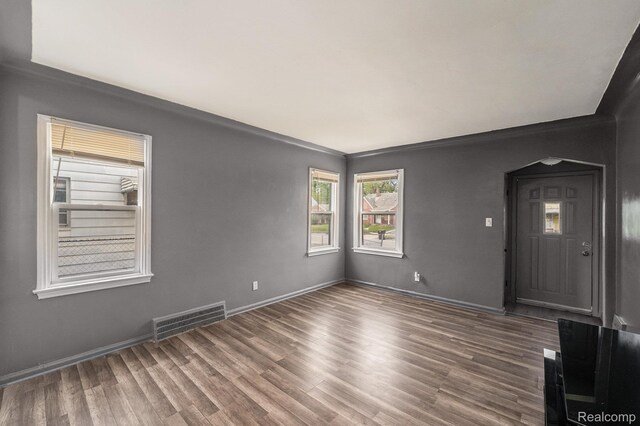 15500 Strathmoor St, Detroit, MI 48227 - unfurnished room with wood finished floors, baseboards, and arched walkways