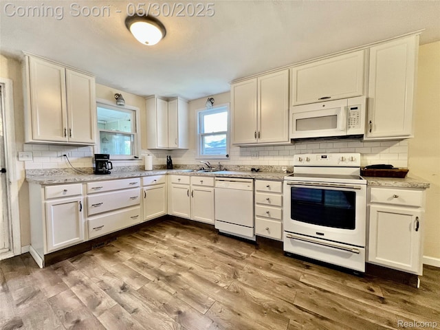1865 Range Rd, Kimball, MI 48074 - kitchen featuring white appliances, wood finished floors, tasteful backsplash, and white cabinetry