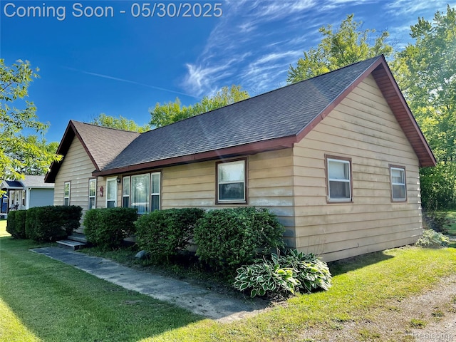 1865 Range Rd, Kimball, MI 48074 - view of side of property featuring roof with shingles and a lawn