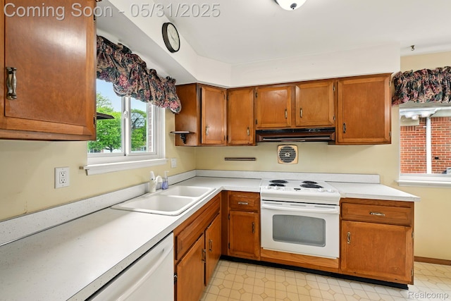 14846 Lakewood Dr, Plymouth, MI 48170 - kitchen with white appliances, under cabinet range hood, a sink, brown cabinets, and light countertops