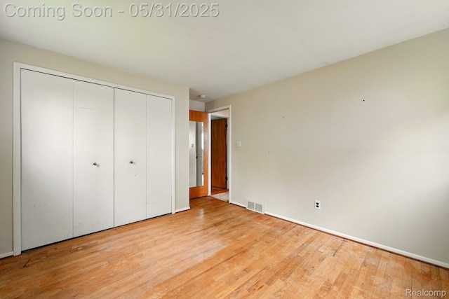 14846 Lakewood Dr, Plymouth, MI 48170 - unfurnished bedroom featuring wood finished floors, a closet, and baseboards