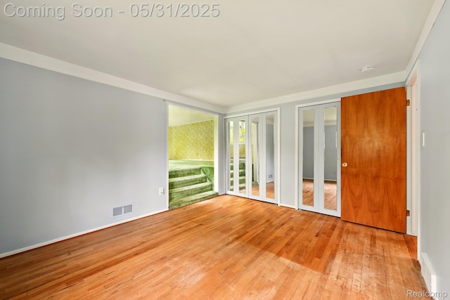 14846 Lakewood Dr, Plymouth, MI 48170 - spare room with wood-type flooring, a smoke detector, and french doors