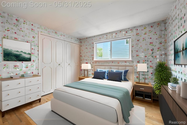 14846 Lakewood Dr, Plymouth, MI 48170 - bedroom with wallpapered walls, light wood-style flooring, and a closet