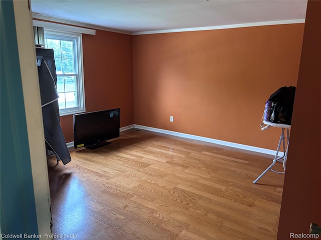 5550 25 Mile Rd, Shelby Twp, MI 48316 - spare room with light wood-style flooring, baseboards, and ornamental molding