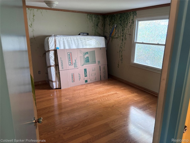 5550 25 Mile Rd, Shelby Twp, MI 48316 - unfurnished bedroom featuring wood finished floors and baseboards