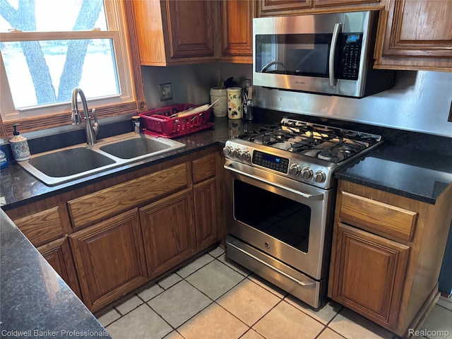 5550 25 Mile Rd, Shelby Twp, MI 48316 - kitchen featuring appliances with stainless steel finishes, a sink, dark countertops, and light tile patterned floors