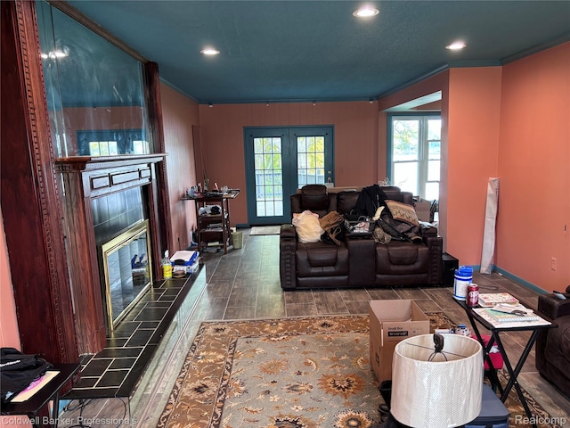5550 25 Mile Rd, Shelby Twp, MI 48316 - living area with a tile fireplace, ornamental molding, wood finished floors, recessed lighting, and french doors