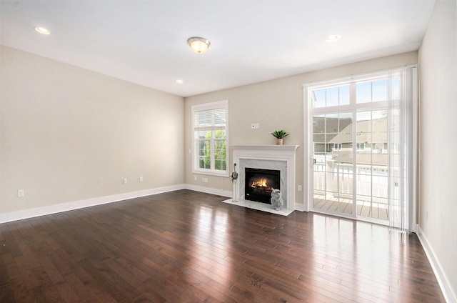 2512 W Liberty St, Ann Arbor, MI 48103 - unfurnished living room featuring dark wood finished floors, baseboards, a premium fireplace, and recessed lighting
