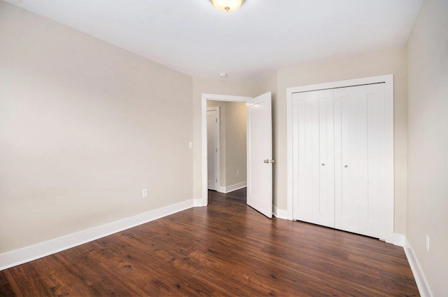 2512 W Liberty St, Ann Arbor, MI 48103 - unfurnished bedroom featuring baseboards, dark wood-style floors, and a closet