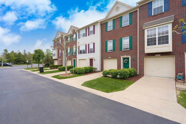 36438 Dominion Cir, Sterling Heights, MI 48310 - townhome / multi-family property featuring concrete driveway, brick siding, and an attached garage