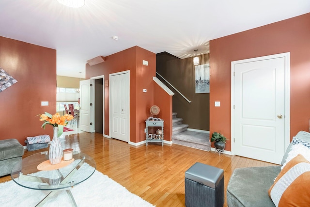 36438 Dominion Cir, Sterling Heights, MI 48310 - living room featuring light wood-type flooring, stairway, and baseboards