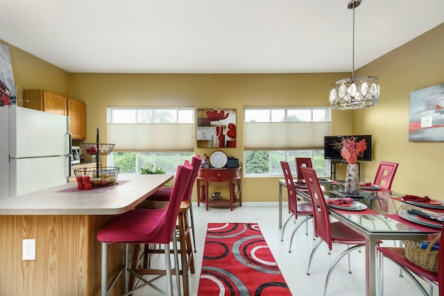 36438 Dominion Cir, Sterling Heights, MI 48310 - dining area featuring healthy amount of natural light, a chandelier, light colored carpet, and baseboards