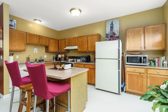 36438 Dominion Cir, Sterling Heights, MI 48310 - kitchen with white appliances, under cabinet range hood, light countertops, a kitchen bar, and a kitchen island
