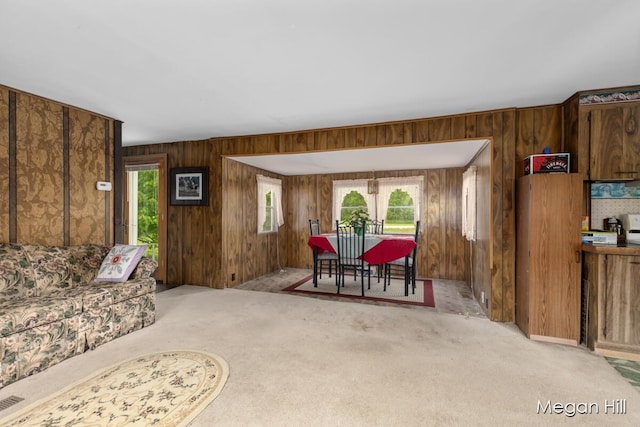 3570 109th Ave, Allegan, MI 49010 - dining space with wooden walls, light colored carpet, and plenty of natural light