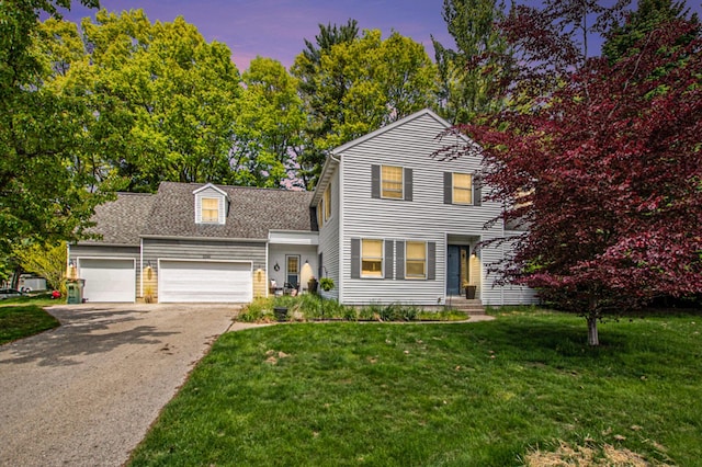 2290 Blissfield Ct, Muskegon, MI 49441 - traditional-style house featuring asphalt driveway, a garage, a lawn, and roof with shingles