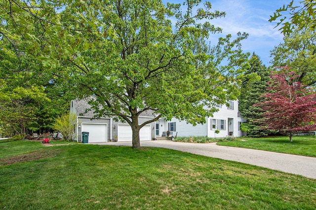 2290 Blissfield Ct, Muskegon, MI 49441 - obstructed view of property with concrete driveway, a front lawn, and a garage