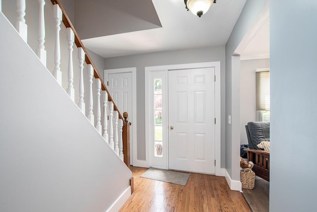 2290 Blissfield Ct, Muskegon, MI 49441 - entryway with baseboards, wood finished floors, and stairway
