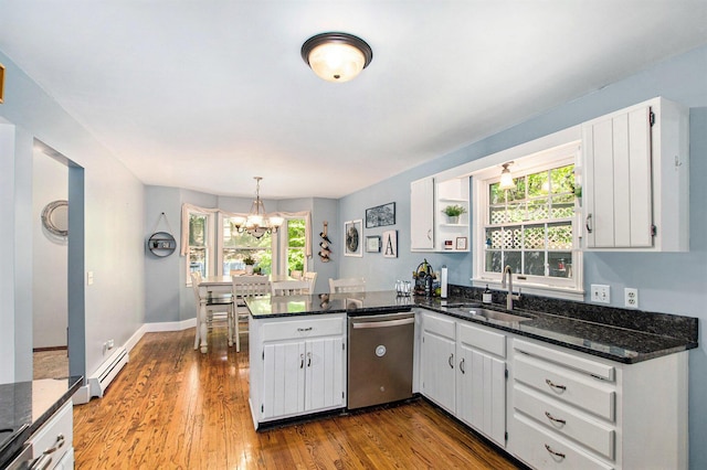 2290 Blissfield Ct, Muskegon, MI 49441 - kitchen featuring stainless steel dishwasher, a sink, a baseboard radiator, a peninsula, and a chandelier