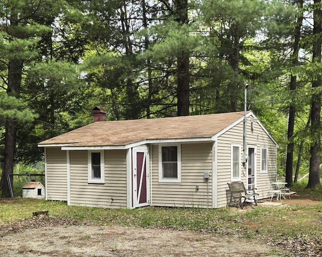 1385 W Channel St, Bitely, MI 49309 - view of front of house featuring a chimney