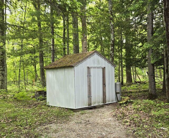 1385 W Channel St, Bitely, MI 49309 - view of shed featuring a forest view