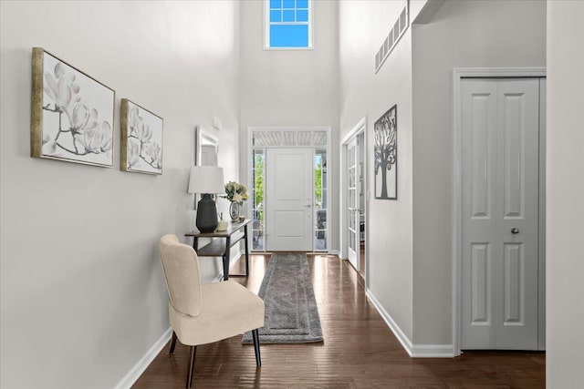 310 Fletcher St, Wixom, MI 48393 - entryway featuring baseboards, healthy amount of natural light, wood finished floors, and a towering ceiling