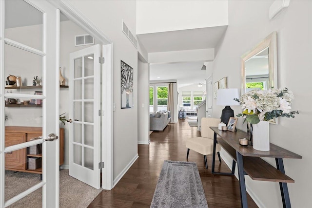 310 Fletcher St, Wixom, MI 48393 - hallway with dark wood finished floors, french doors, a high ceiling, and baseboards