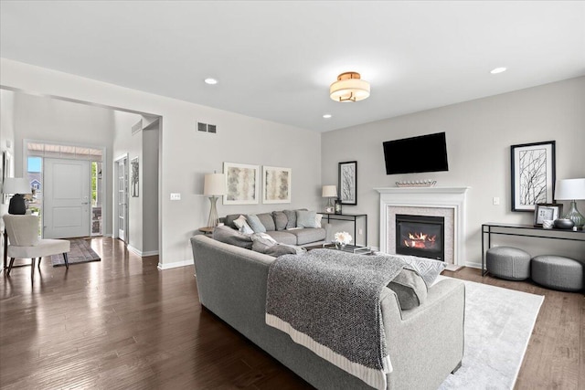 310 Fletcher St, Wixom, MI 48393 - living room with recessed lighting, a glass covered fireplace, dark wood-style floors, and baseboards