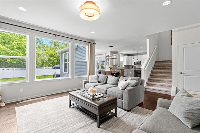 310 Fletcher St, Wixom, MI 48393 - living room with plenty of natural light, wood finished floors, stairway, baseboards, and recessed lighting