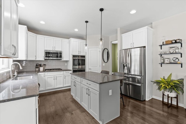 310 Fletcher St, Wixom, MI 48393 - kitchen with stainless steel appliances, a sink, dark wood-style flooring, backsplash, and recessed lighting