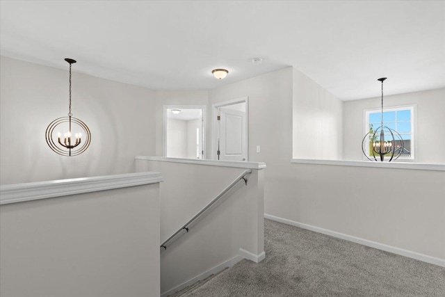 310 Fletcher St, Wixom, MI 48393 - hallway with a chandelier, an upstairs landing, baseboards, and carpet floors