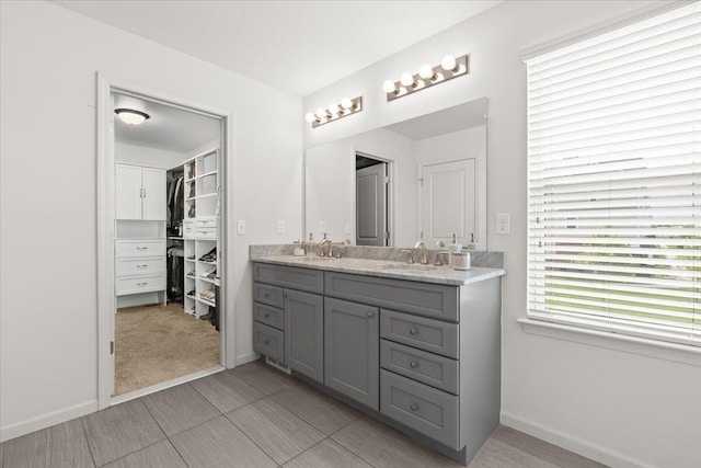 310 Fletcher St, Wixom, MI 48393 - full bath with double vanity, baseboards, and a spacious closet