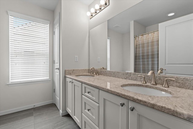 310 Fletcher St, Wixom, MI 48393 - bathroom with double vanity and baseboards