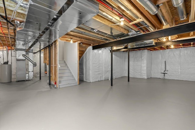 310 Fletcher St, Wixom, MI 48393 - unfinished below grade area with stairway, water heater, and heating unit