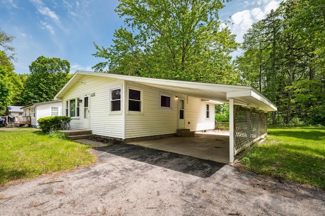 6185 N Shore Dr, Coloma, MI 49038 - view of front of home with asphalt driveway, a front yard, and an attached carport