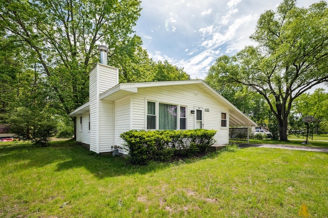 6185 N Shore Dr, Coloma, MI 49038 - view of side of home with a chimney, a lawn, and asphalt driveway