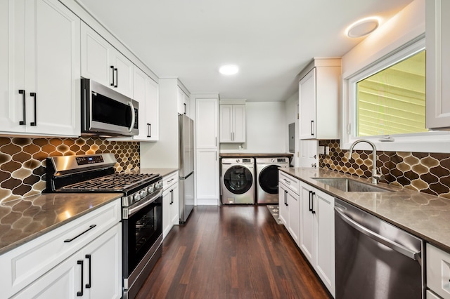 6185 N Shore Dr, Coloma, MI 49038 - kitchen featuring appliances with stainless steel finishes, washer and clothes dryer, a sink, dark wood-style floors, and white cabinets