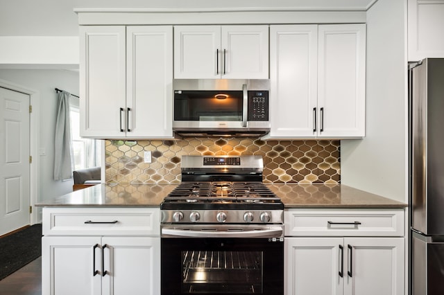 6185 N Shore Dr, Coloma, MI 49038 - kitchen featuring appliances with stainless steel finishes, white cabinets, and decorative backsplash