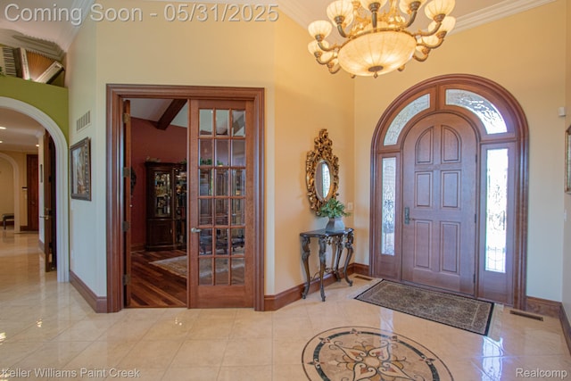 72755 Solanus Dr, Bruce, MI 48065 - entrance foyer featuring arched walkways, baseboards, a chandelier, a towering ceiling, and crown molding