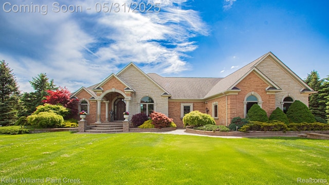 72755 Solanus Dr, Bruce, MI 48065 - view of front of property featuring a front lawn, brick siding, and stone siding