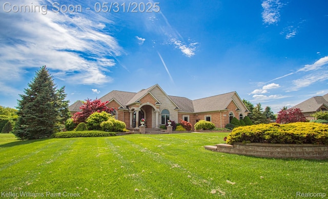 72755 Solanus Dr, Bruce, MI 48065 - traditional-style house with a front yard and brick siding
