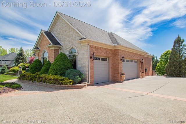 72755 Solanus Dr, Bruce, MI 48065 - view of side of home featuring an attached garage, brick siding, concrete driveway, stone siding, and roof with shingles