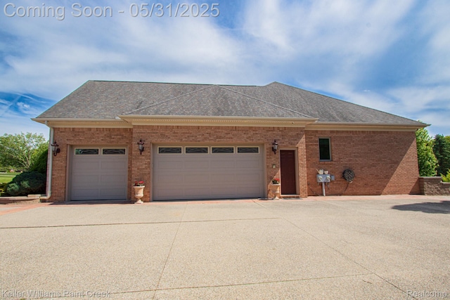 72755 Solanus Dr, Bruce, MI 48065 - view of front facade featuring a garage, concrete driveway, brick siding, and roof with shingles
