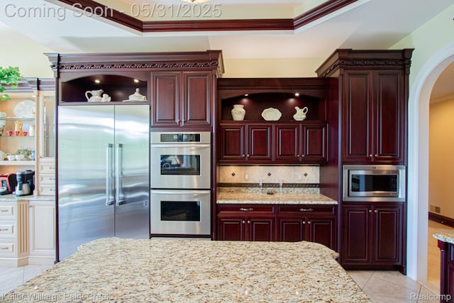 72755 Solanus Dr, Bruce, MI 48065 - kitchen featuring built in appliances, arched walkways, light tile patterned floors, crown molding, and dark brown cabinets