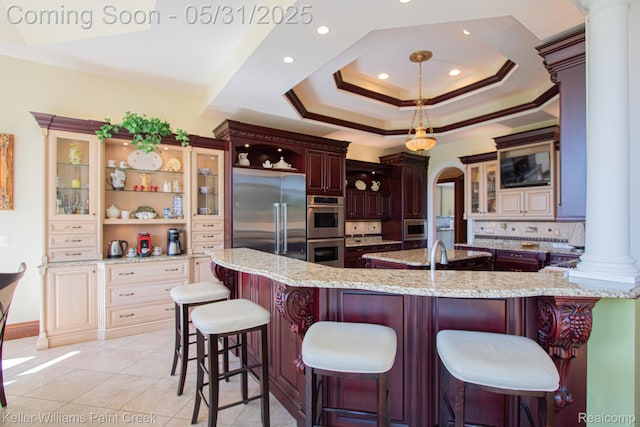 72755 Solanus Dr, Bruce, MI 48065 - kitchen featuring built in appliances, decorative columns, glass insert cabinets, backsplash, and light stone counters