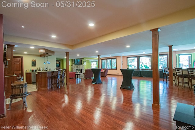 72755 Solanus Dr, Bruce, MI 48065 - exercise area featuring ornate columns, bar with sink, plenty of natural light, and recessed lighting