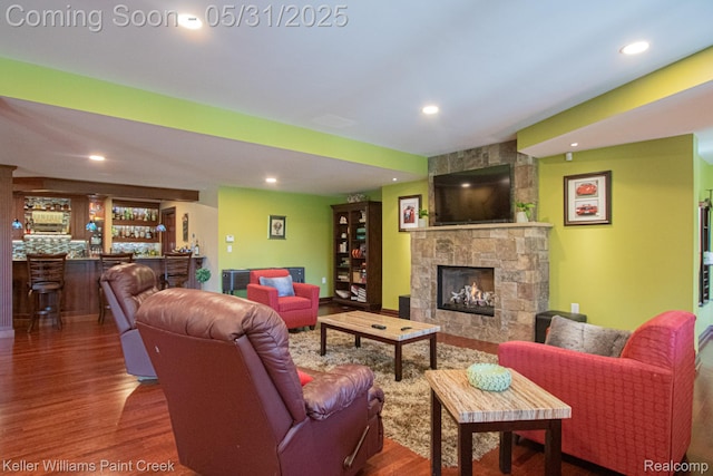72755 Solanus Dr, Bruce, MI 48065 - living area featuring bar, wood finished floors, a fireplace, and recessed lighting