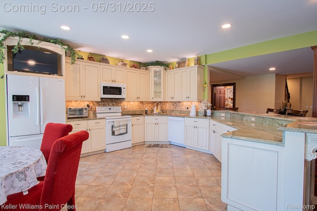72755 Solanus Dr, Bruce, MI 48065 - kitchen with white appliances, a peninsula, tasteful backsplash, glass insert cabinets, and light stone counters