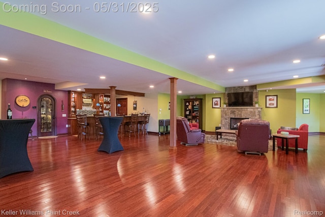 72755 Solanus Dr, Bruce, MI 48065 - living room featuring bar, wood finished floors, a fireplace, recessed lighting, and baseboards