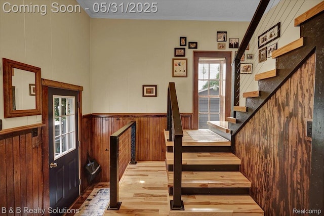 6624 Jefferson Rd, North Branch, MI 48461 - staircase featuring wood finished floors, ornamental molding, wainscoting, and wood walls