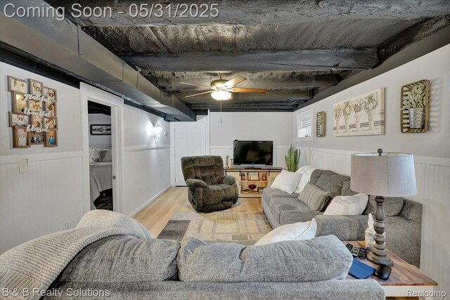 6624 Jefferson Rd, North Branch, MI 48461 - living room featuring wood finished floors, a wainscoted wall, and a ceiling fan